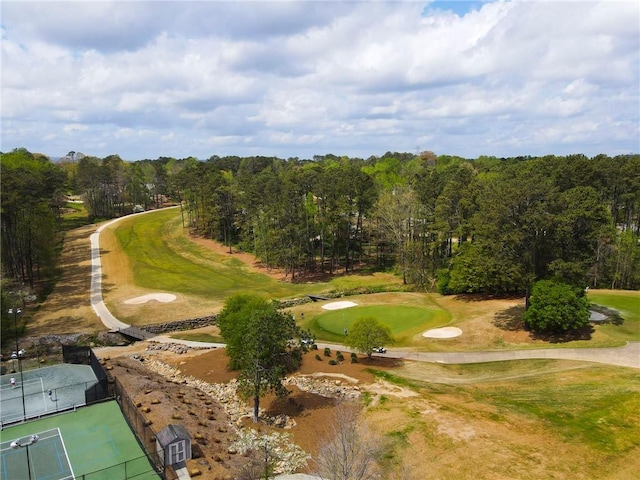 surrounding community featuring a view of trees and view of golf course