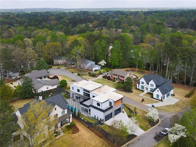aerial view featuring a wooded view and a residential view