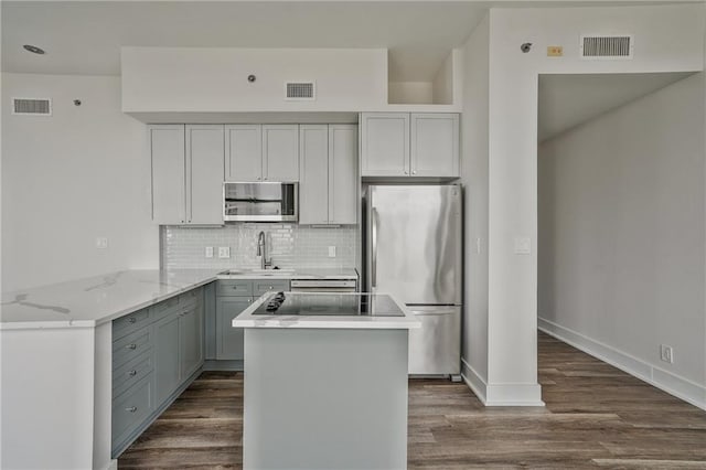 57 Forsyth St NW Unit 14B, Atlanta, GA 30303 - kitchen featuring appliances with stainless steel finishes, a sink, gray cabinets, tasteful backsplash, and dark wood-style flooring