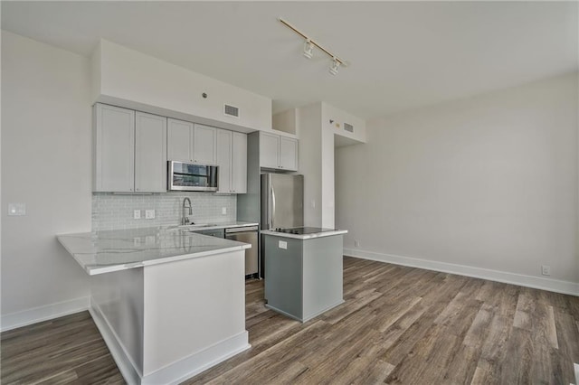 57 Forsyth St NW Unit 14B, Atlanta, GA 30303 - kitchen featuring stainless steel appliances, rail lighting, a sink, decorative backsplash, and light countertops