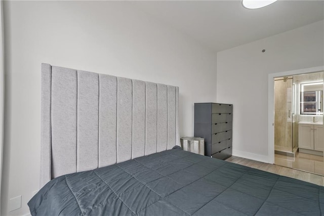 57 Forsyth St NW Unit 14B, Atlanta, GA 30303 - bedroom with wood finished floors, baseboards, and ensuite bathroom