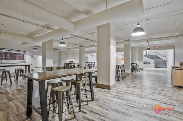 57 Forsyth St NW Unit 14B, Atlanta, GA 30303 - dining area with light wood-style flooring, stairway, and baseboards