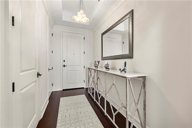 doorway to outside featuring dark wood finished floors and an inviting chandelier