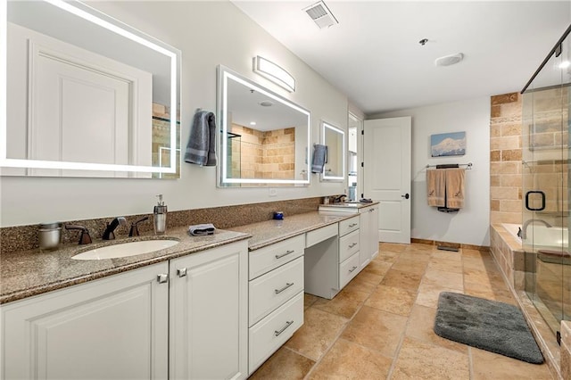 full bath featuring vanity, visible vents, and a stall shower