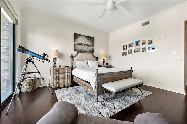 bedroom with visible vents, ornamental molding, a ceiling fan, wood finished floors, and baseboards