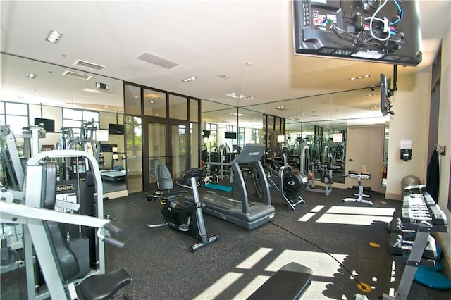 gym with visible vents and expansive windows