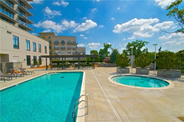 pool featuring a patio and a hot tub