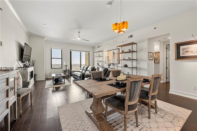 dining space with visible vents, ornamental molding, baseboards, and dark wood-style flooring