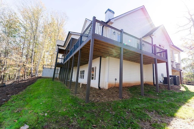 view of property exterior featuring stairway, a yard, central AC unit, and a wooden deck