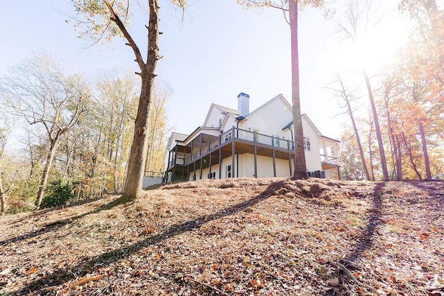 rear view of house featuring a chimney