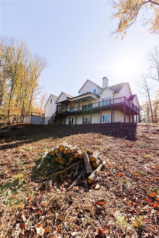 back of house featuring a chimney