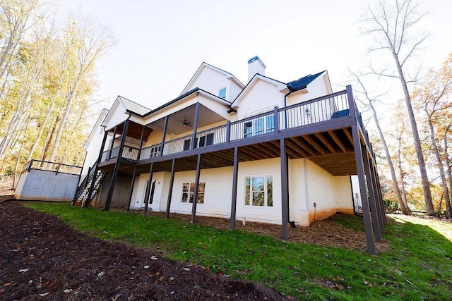 back of property featuring a chimney, a wooden deck, stairs, and ceiling fan