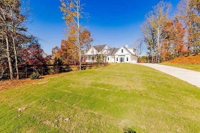 view of front of house with concrete driveway and a front yard