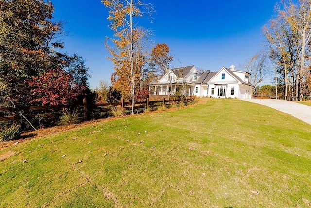 view of front of house with a front yard, an attached garage, and driveway