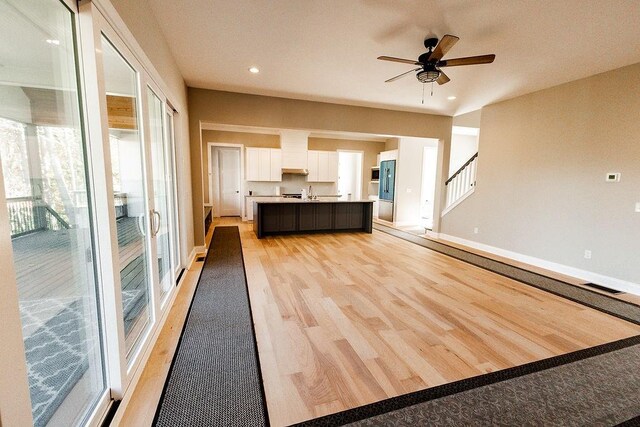 unfurnished living room with visible vents, recessed lighting, light wood-style floors, baseboards, and ceiling fan