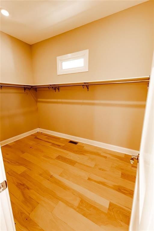 spacious closet featuring visible vents and light wood-type flooring