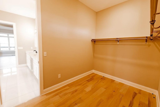 spacious closet with light wood-style flooring