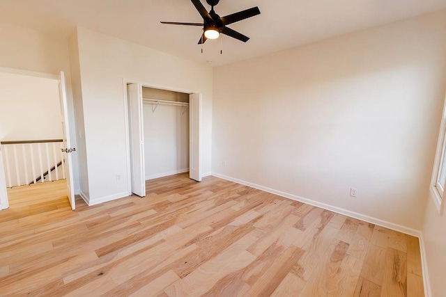 unfurnished bedroom with a closet, baseboards, light wood-style floors, and ceiling fan