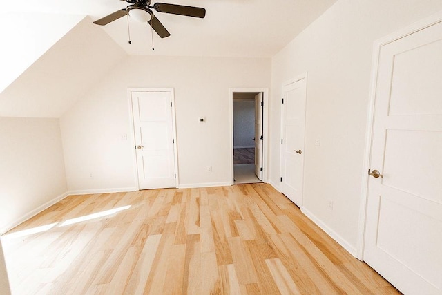 bonus room featuring lofted ceiling, a ceiling fan, light wood-type flooring, and baseboards