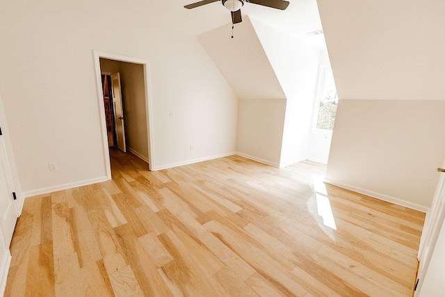 additional living space featuring light wood finished floors, baseboards, lofted ceiling, and ceiling fan