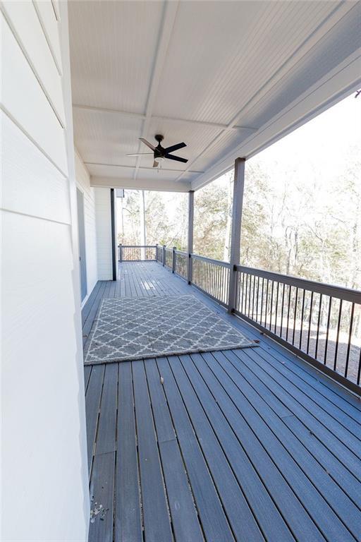 wooden terrace featuring a ceiling fan