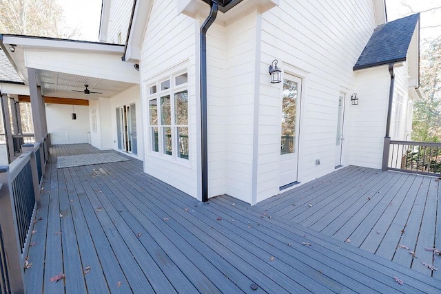 wooden deck with a ceiling fan