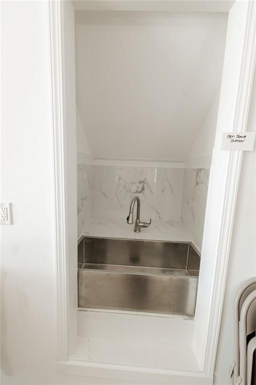 bathroom featuring vaulted ceiling