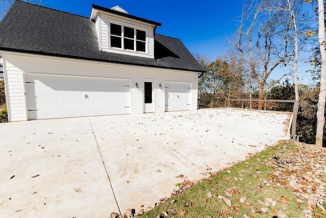 detached garage featuring fence