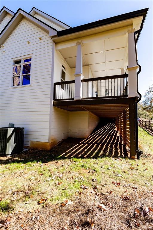 rear view of house featuring central AC unit