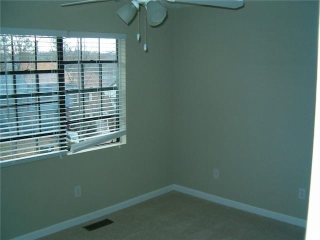 empty room with ceiling fan and carpet floors