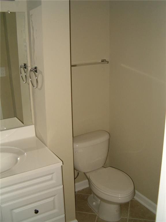 bathroom featuring tile patterned flooring, vanity, and toilet