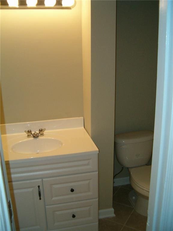 bathroom featuring tile patterned floors, vanity, and toilet