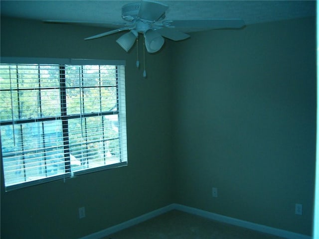 spare room featuring ceiling fan and a healthy amount of sunlight