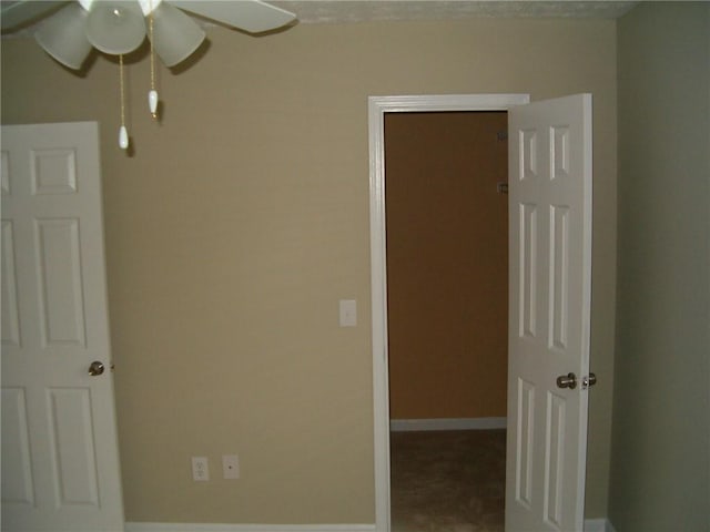 unfurnished bedroom featuring ceiling fan