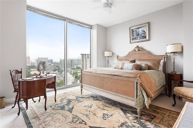 2795 Peachtree Rd NE Unit 2101, Atlanta, GA 30305 - bedroom featuring floor to ceiling windows, light carpet, a city view, and a ceiling fan