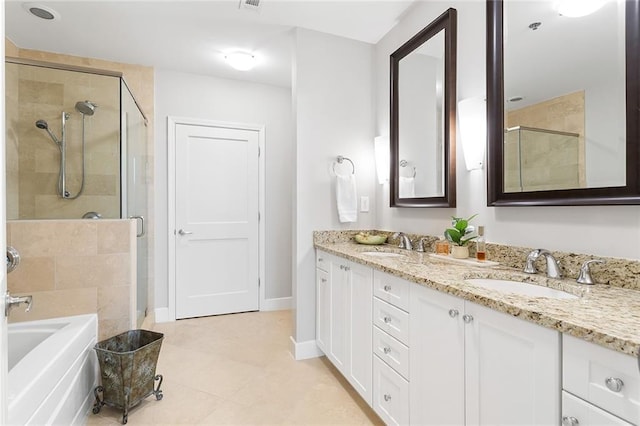 2795 Peachtree Rd NE Unit 2101, Atlanta, GA 30305 - full bathroom with a stall shower, a garden tub, double vanity, tile patterned floors, and baseboards