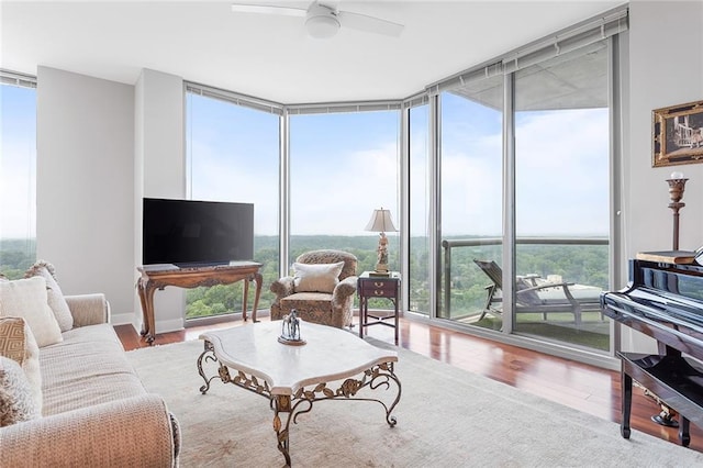 2795 Peachtree Rd NE Unit 2101, Atlanta, GA 30305 - living area with expansive windows, healthy amount of natural light, wood finished floors, and ceiling fan