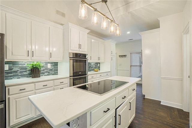 kitchen with black electric stovetop, stainless steel double oven, and white cabinets