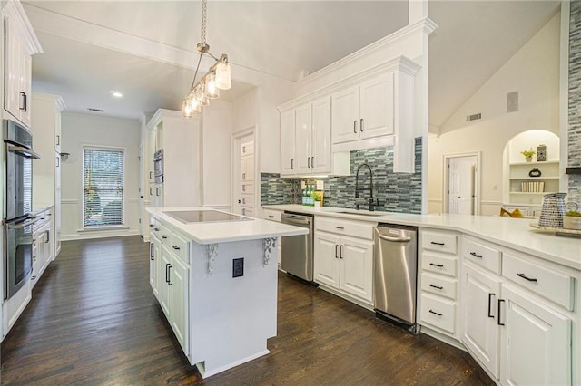 kitchen with a kitchen island, decorative light fixtures, white cabinetry, sink, and stainless steel appliances