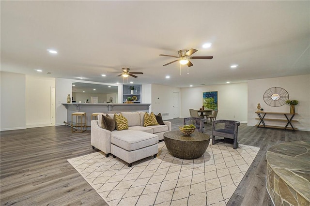 living room with ceiling fan and light wood-type flooring