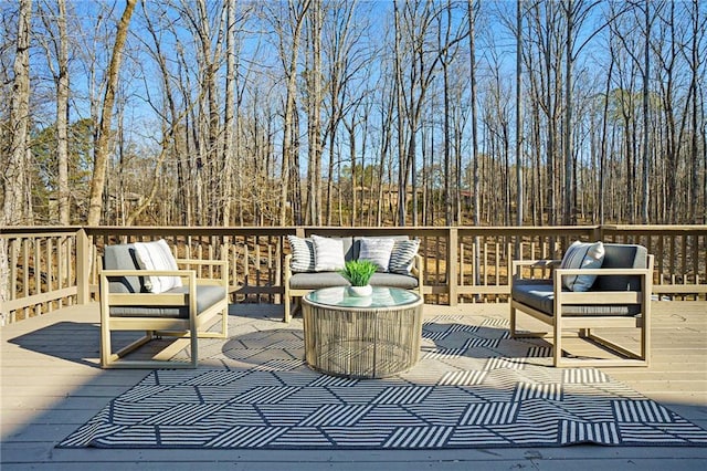 wooden terrace with an outdoor living space