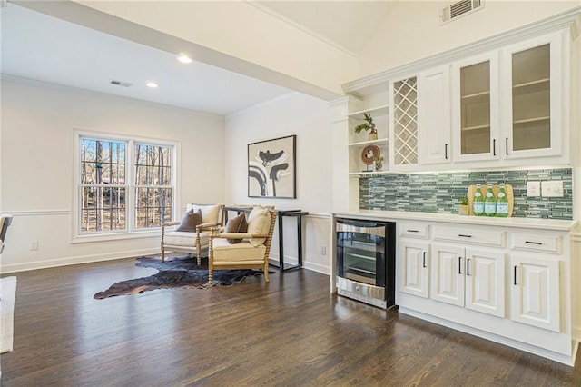 bar featuring backsplash, dark hardwood / wood-style floors, wine cooler, ornamental molding, and white cabinets