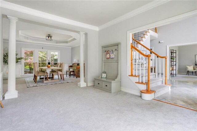 interior space featuring stairs, carpet flooring, decorative columns, and ornamental molding