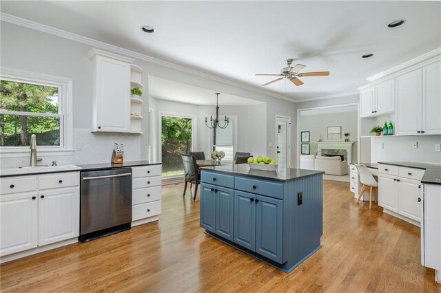 kitchen featuring stainless steel dishwasher, open shelves, white cabinetry, and blue cabinets
