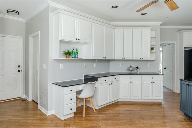 kitchen with crown molding, open shelves, and dark countertops