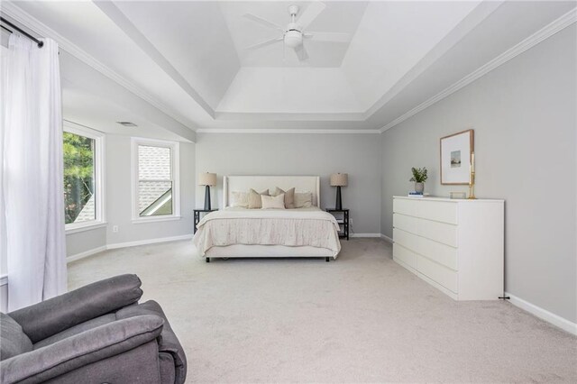 carpeted bedroom featuring crown molding, ceiling fan, baseboards, and a raised ceiling