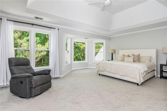 carpeted bedroom with visible vents, a raised ceiling, baseboards, and a ceiling fan