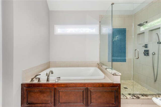 bathroom with a garden tub and a stall shower