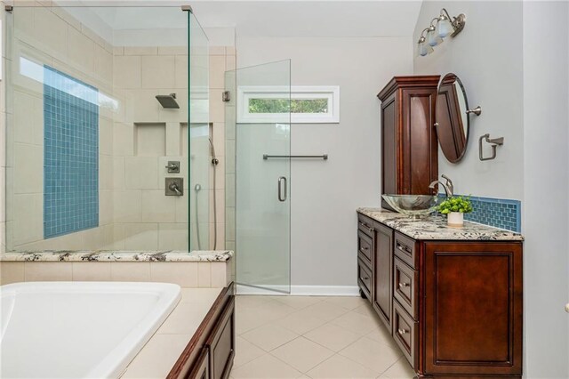full bathroom with vanity, tile patterned flooring, a bath, and a stall shower