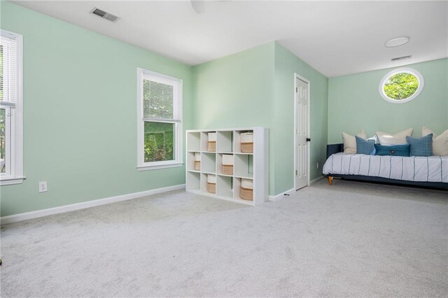 bedroom featuring baseboards, visible vents, and carpet